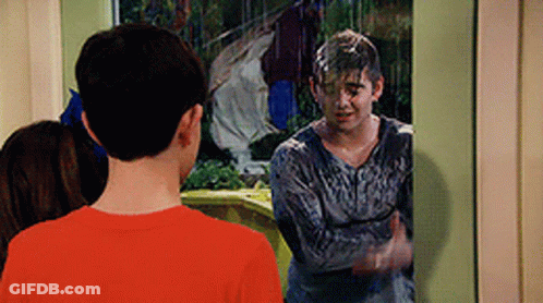 A Boy In A Red Shirt Is Standing In Front Of A Window With A Man In A Gray Shirt Covered In Slime . GIF
