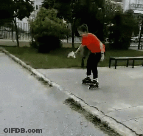 A Boy In A Red Shirt Rollerblading Down A Sidewalk GIF