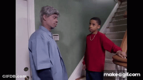 A Boy In A Red Sweater Is Standing Next To A Man In A Blue Shirt GIF