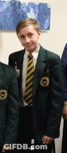 A Boy In A School Uniform Has A Patch On His Jacket That Says ' Williams ' On It GIF