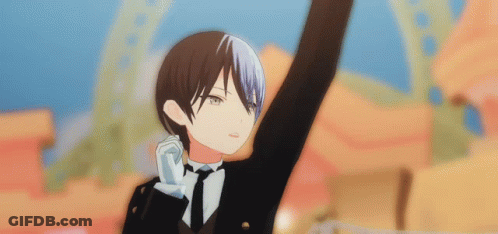 A Boy In A Tuxedo And Tie Is Raising His Hand In The Air . GIF