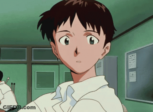 A Boy In A White Shirt Is Sitting In Front Of A Green Locker GIF