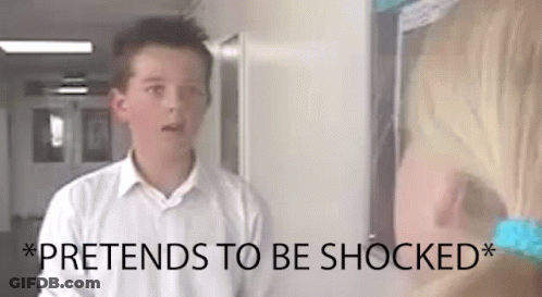 A Boy In A White Shirt Is Standing Next To A Girl In A Hallway And The Girl Is Shocked . GIF