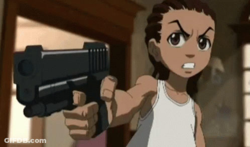 A Boy In A White Tank Top Is Pointing A Gun At The Camera GIF