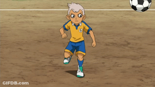 A Boy In A Yellow And Blue Shirt With The Letter S On It GIF