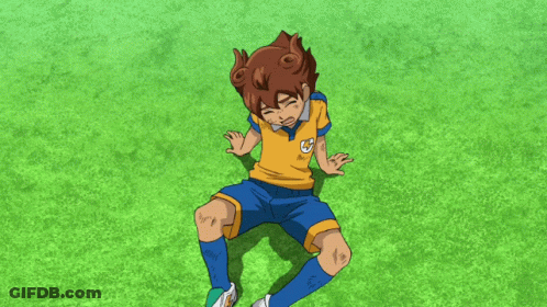 A Boy In A Yellow Shirt And Blue Shorts Is Laying On The Grass With His Hands Reaching Out Towards Him GIF