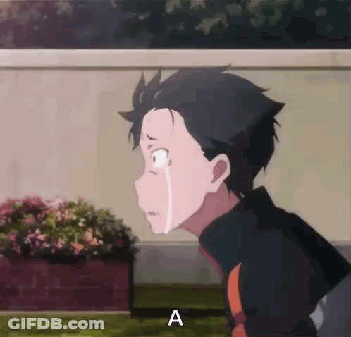 A Boy Is Crying While Standing In Front Of A Planter Of Flowers . GIF