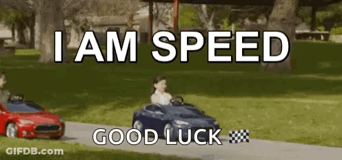 A Boy Is Driving A Toy Car Down A Road . GIF