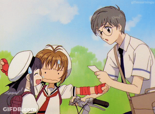 A Boy Is Giving A Piece Of Paper To A Girl Who Is Holding A Bicycle GIF