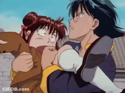 A Boy Is Holding A Girl In His Arms And The Girl Is Making A Funny Face GIF