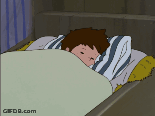 A Boy Is Laying In Bed With A Striped Pillow GIF