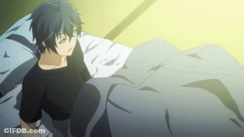 A Boy Is Laying On A Bed With A Blanket GIF