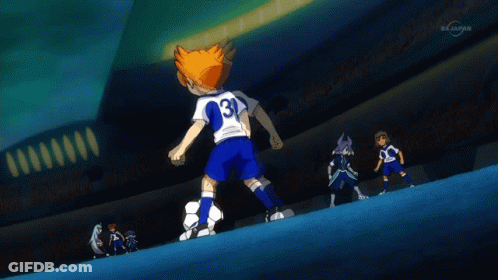A Boy Kicking A Soccer Ball In Front Of A Stadium That Says Tvtokyo GIF
