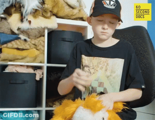 A Boy Playing With A Stuffed Animal In Front Of A 60 Second Docs Logo GIF