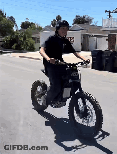 A Boy Riding A Dirt Bike With The Number 427 On The Front GIF