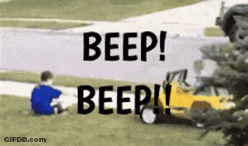 A Boy Sits In The Grass With The Words Beep Beep Written Above Him GIF