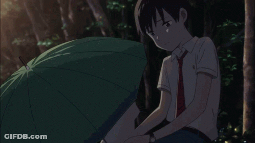 A Boy Sits Under An Umbrella With His Head Down GIF