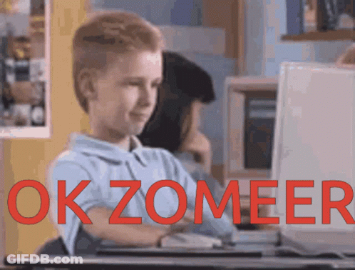 A Boy Sitting In Front Of A Computer With The Words Okzomeer Written In Red GIF