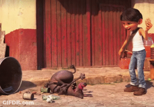 A Boy Standing Next To A Dog That Is Laying On The Ground With Its Mouth Open GIF
