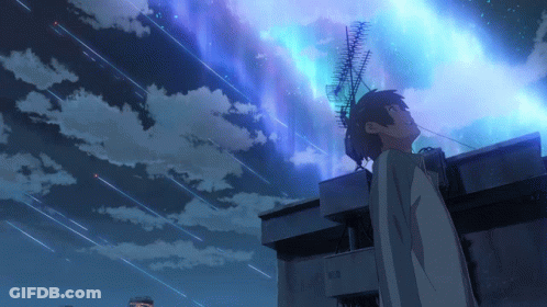 A Boy Stands On The Roof Of A Building Looking Up At The Night Sky GIF