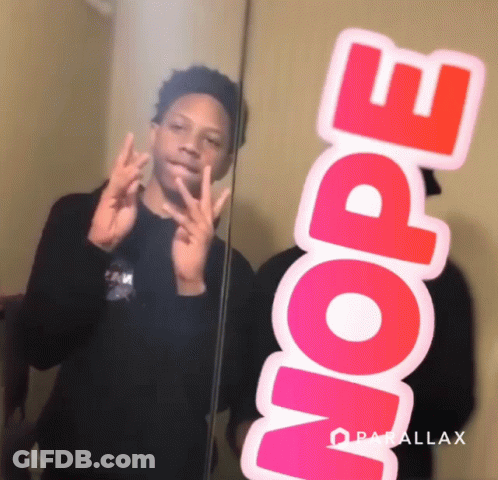 A Boy Taking A Picture Of Himself In A Mirror With A Sticker That Says Nope On It GIF