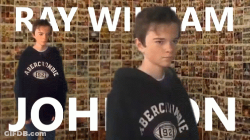 A Boy Wearing A Black Abercrombie Sweatshirt Stands In Front Of A Wall GIF