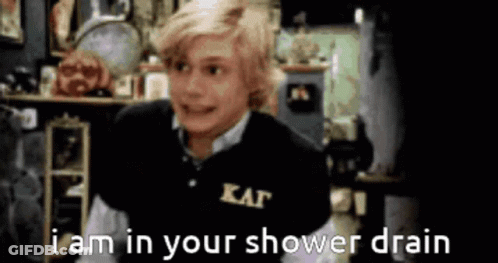 A Boy Wearing A Black Shirt That Says Kappa On It Says I Am In Your Shower Drain GIF