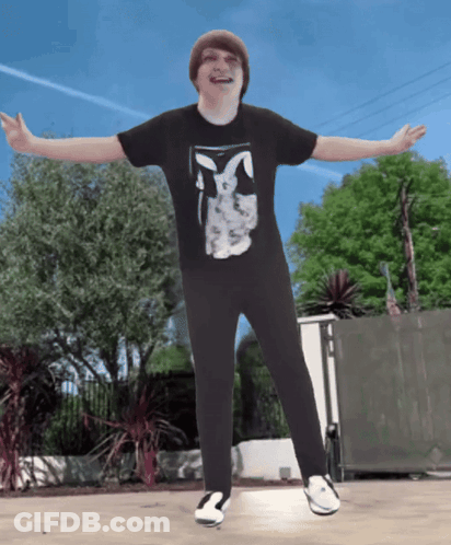 A Boy Wearing A Black Shirt With A Bunny On It GIF