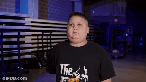 A Boy Wearing A Black T-Shirt That Says " The Godfather " GIF