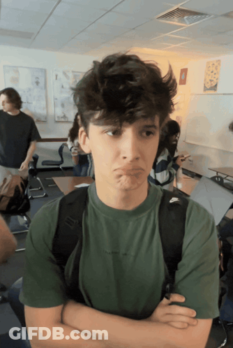 A Boy Wearing A Green Shirt With The Word Nike On The Front GIF