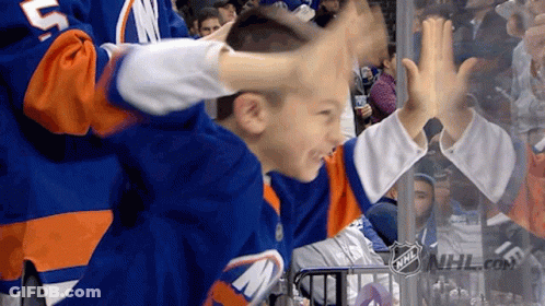 A Boy Wearing A Jersey With The Letter M On It Is Giving A High Five GIF
