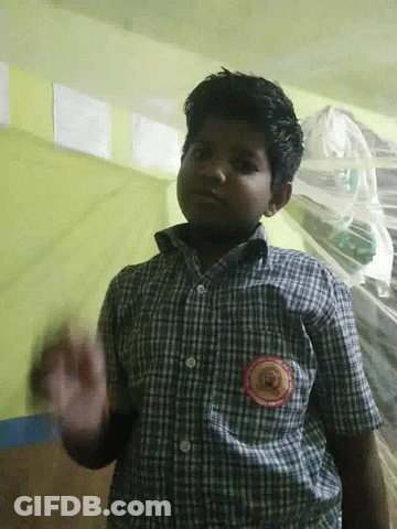 A Boy Wearing A Plaid Shirt Has A Badge On His Chest That Says ' Kerala ' GIF