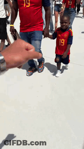 A Boy Wearing A Red Jersey With The Number 19 On It GIF