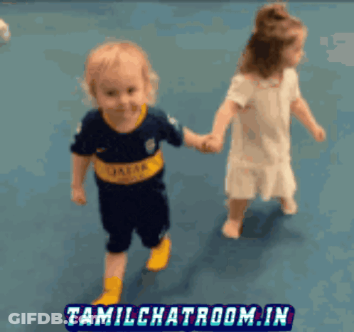 A Boy Wearing A Shirt That Says Caesar Is Holding Hands With A Girl GIF