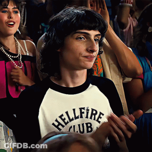 A Boy Wearing A Shirt That Says Hellfire Club On It GIF
