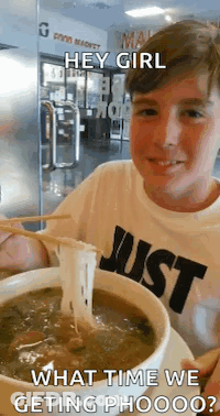 A Boy Wearing A Shirt That Says Just Is Eating Soup With Chopsticks . GIF