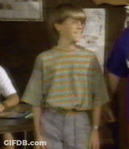 A Boy Wearing A Striped Shirt And Gray Pants GIF