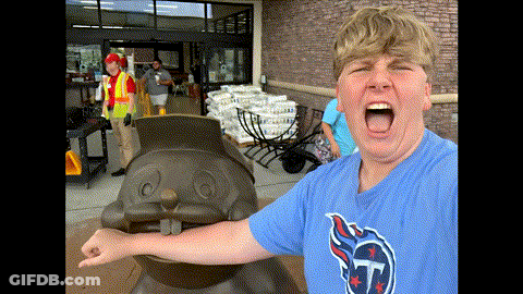 A Boy Wearing A Texans Shirt Stands In Front Of A Statue GIF