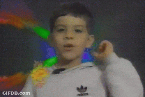 A Boy Wearing A White Adidas Sweatshirt Is Making A Funny Face GIF