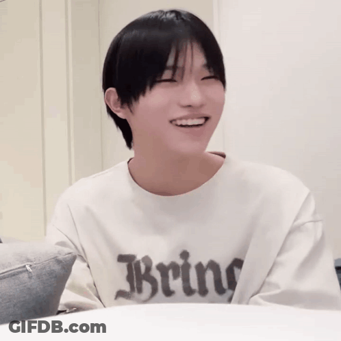 A Boy Wearing A White Shirt That Says Bring On It GIF