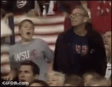 A Boy Wearing A Wsu Shirt Is Screaming In The Stands GIF