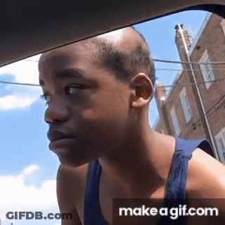 A Boy With A Bald Head Is Looking Out Of A Car Window . GIF