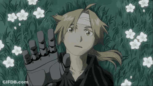 A Boy With A Bandage On His Head Is Laying In The Grass GIF