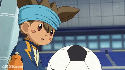 A Boy With A Blue Headband Holds A Soccer Ball In Front Of A Tv Screen That Says Tv Asahi GIF