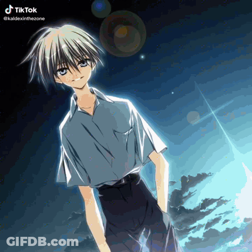 A Boy With A Blue Shirt And Black Shorts Stands In Front Of A Cloudy Sky GIF