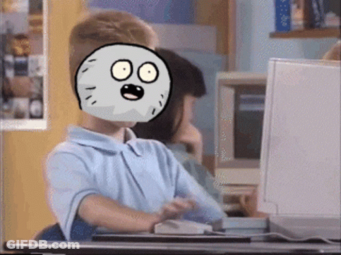 A Boy With A Cartoon Face On His Face Is Sitting At A Desk In Front Of A Computer GIF