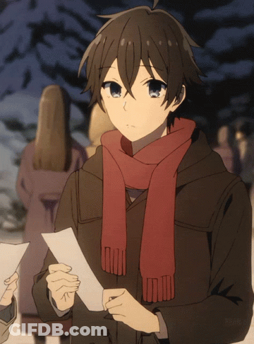 A Boy With A Scarf Around His Neck Holds A Piece Of Paper In His Hand GIF