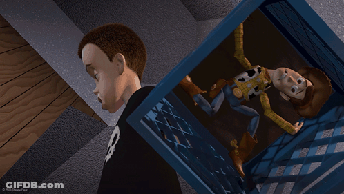 A Boy With A Skull On His Shirt Is Standing Next To A Toy Story Woody GIF