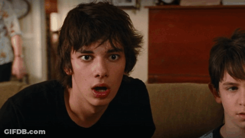 A Boy With A Surprised Look On His Face Looks At The Camera GIF