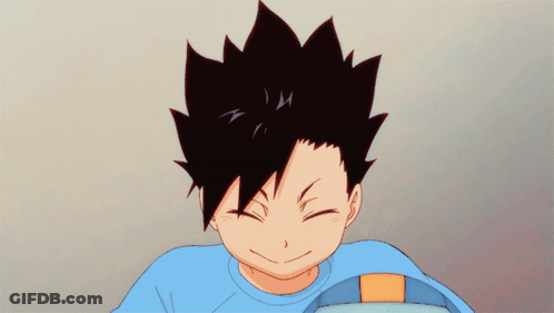 A Boy With Black Hair And A Blue Shirt Is Smiling With His Eyes Closed GIF